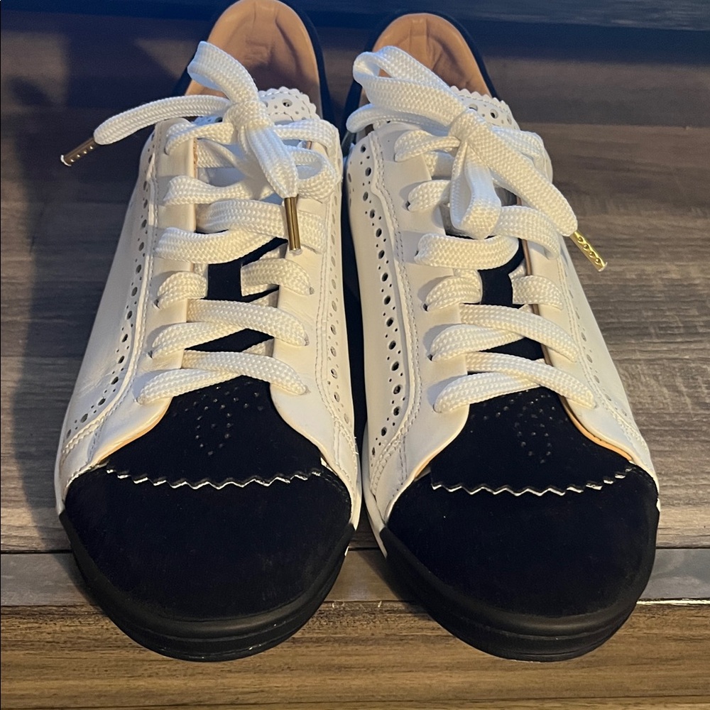 “The office of Angela Scott-White and Black Lace-Up Sneakers
